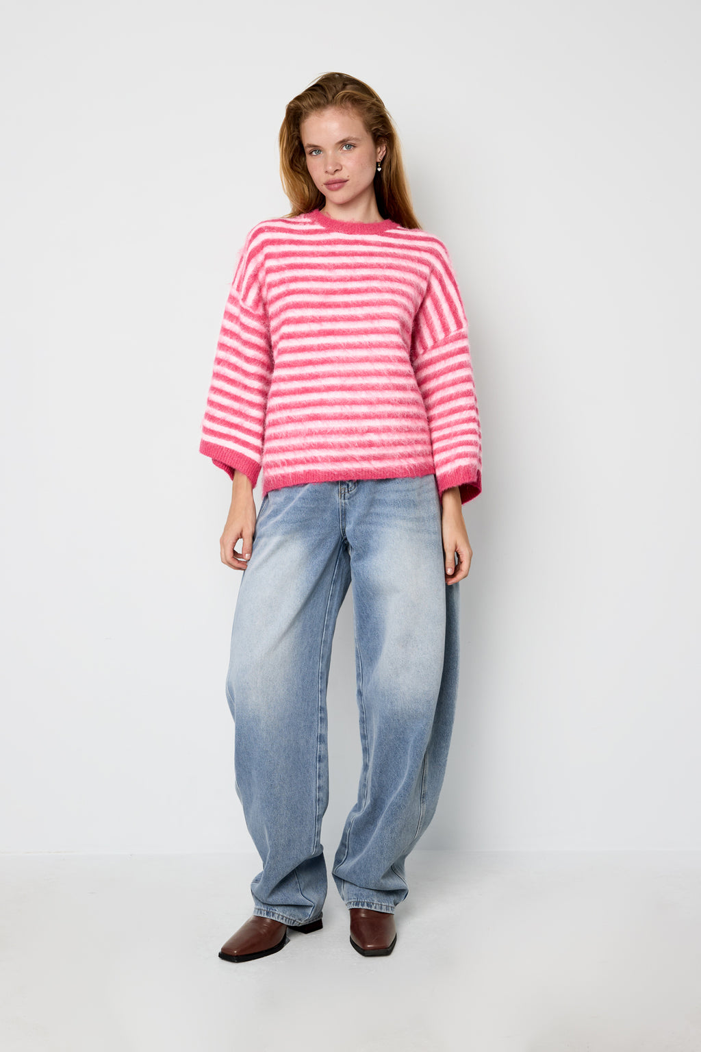 Striped knitted women's sweater with a round neck