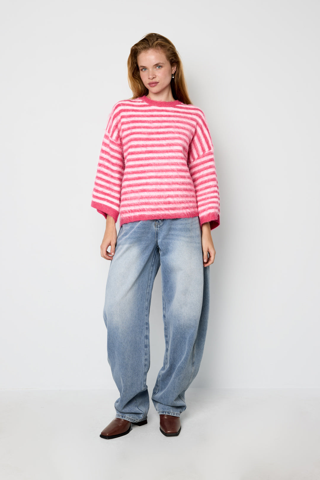 Striped knitted women's sweater with a round neck