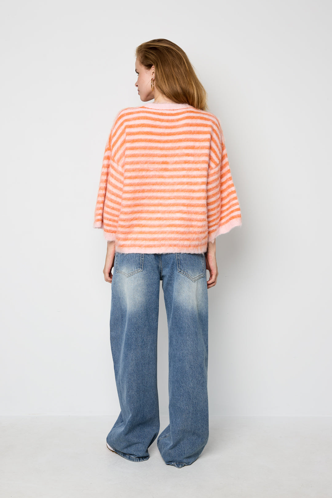 Striped knitted women's sweater with a round neck