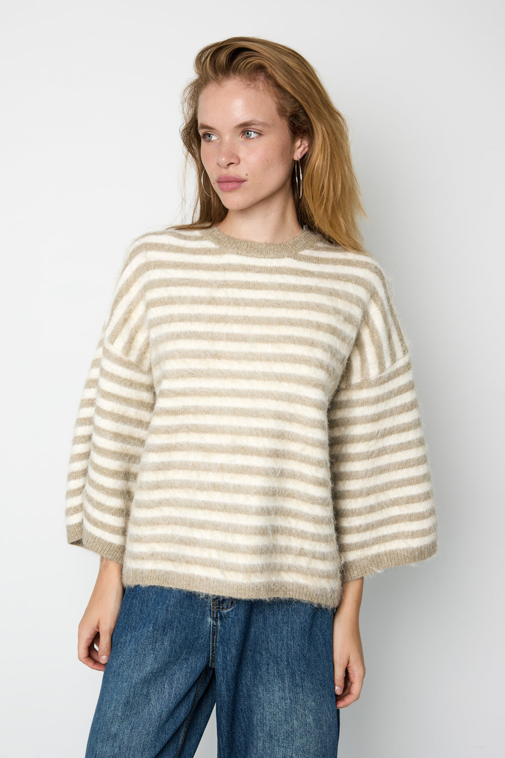 Striped knitted women's sweater with a round neck