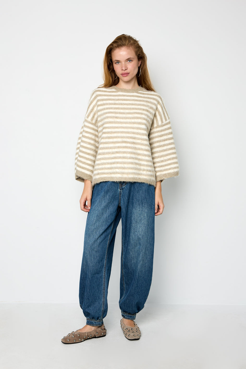 Striped knitted women's sweater with a round neck