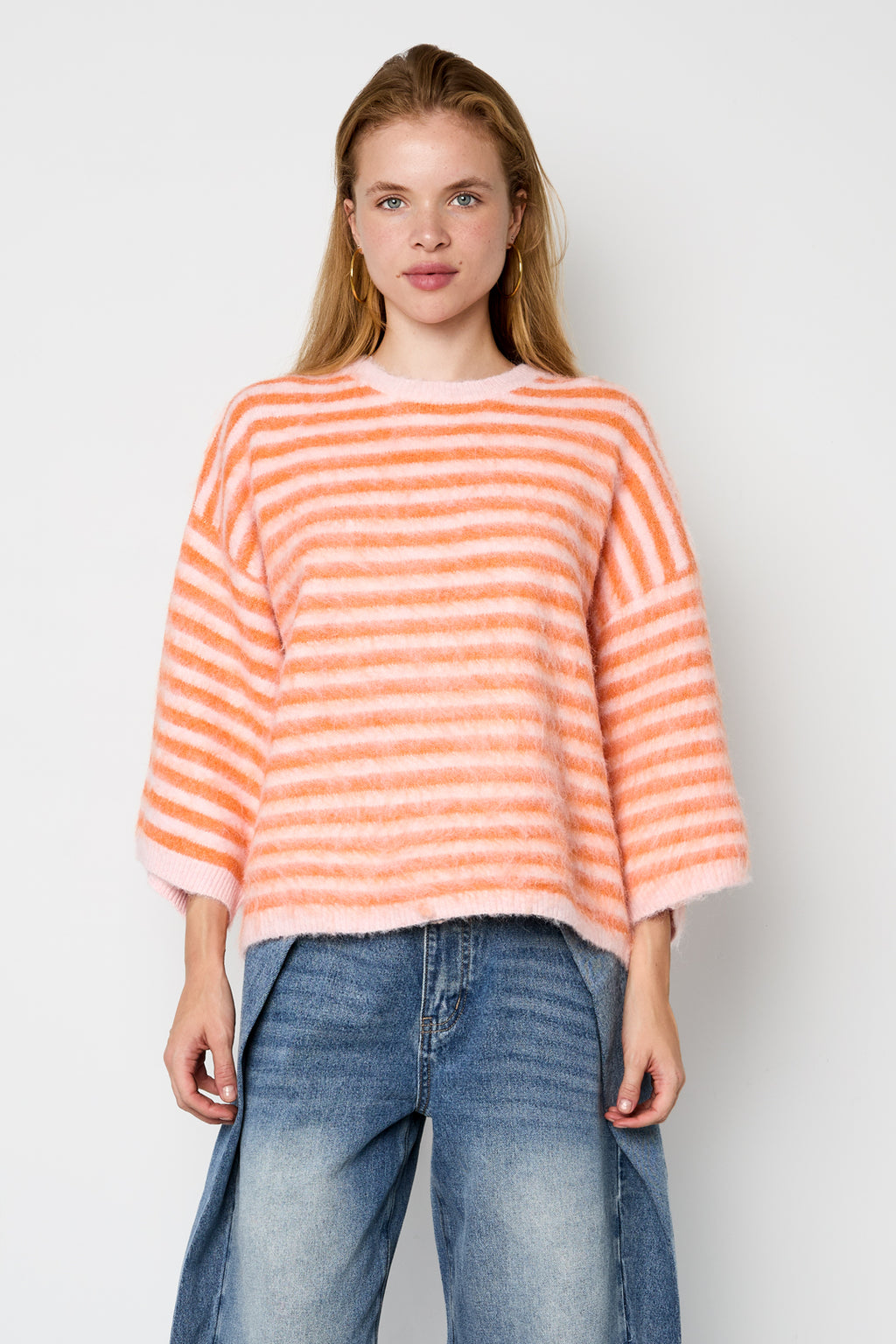 Striped knitted women's sweater with a round neck